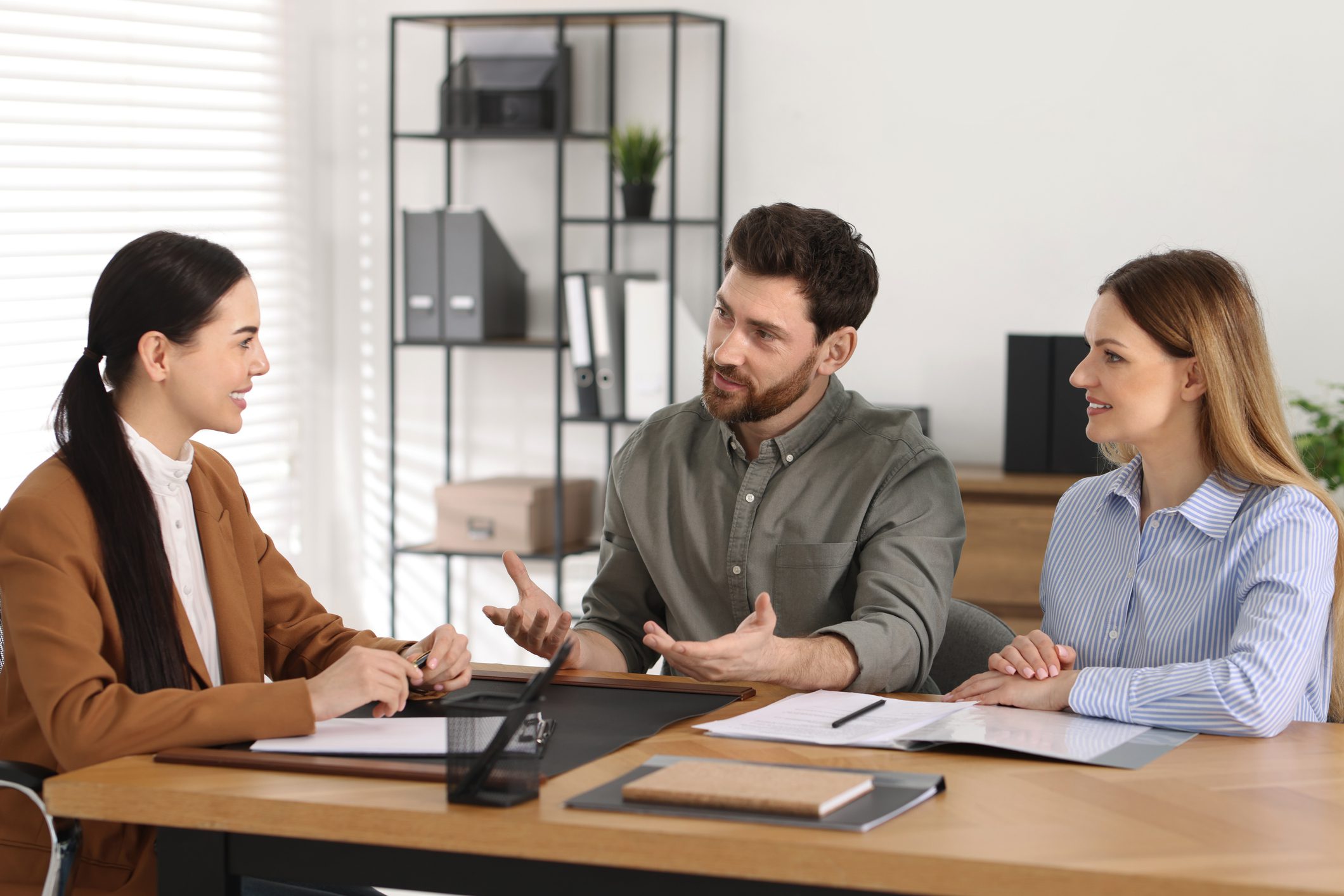 Three people having a business meeting discussion.