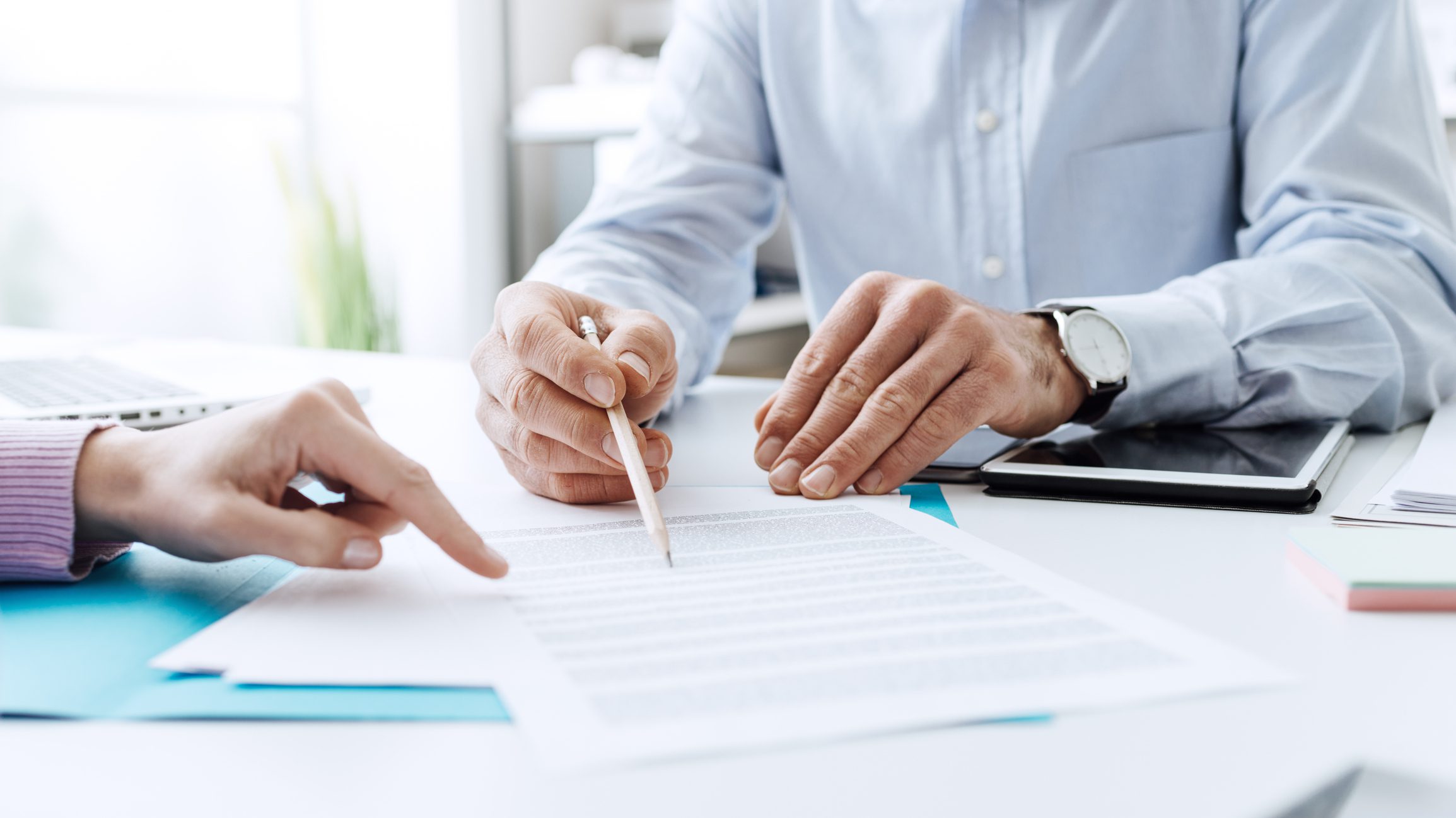 Two people reviewing and discussing a document.