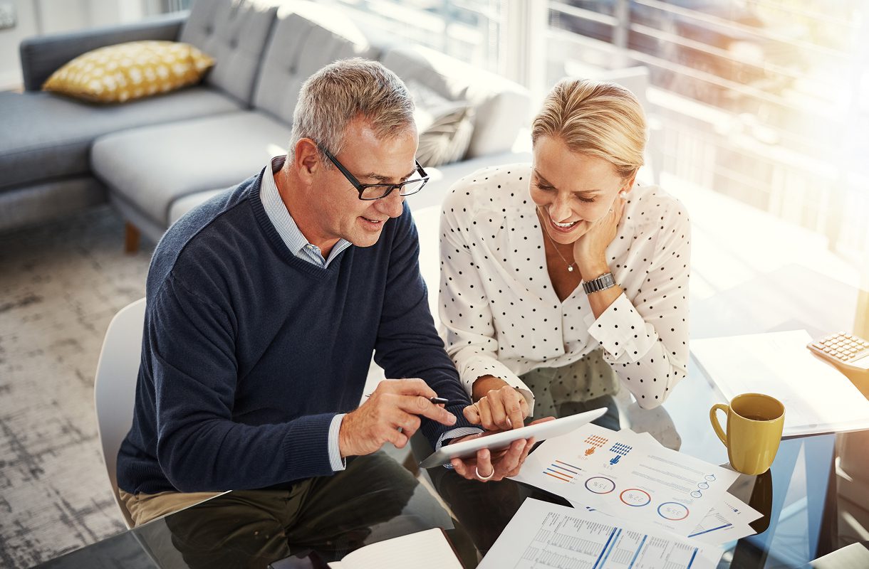 Couple reviewing documents with a tablet.